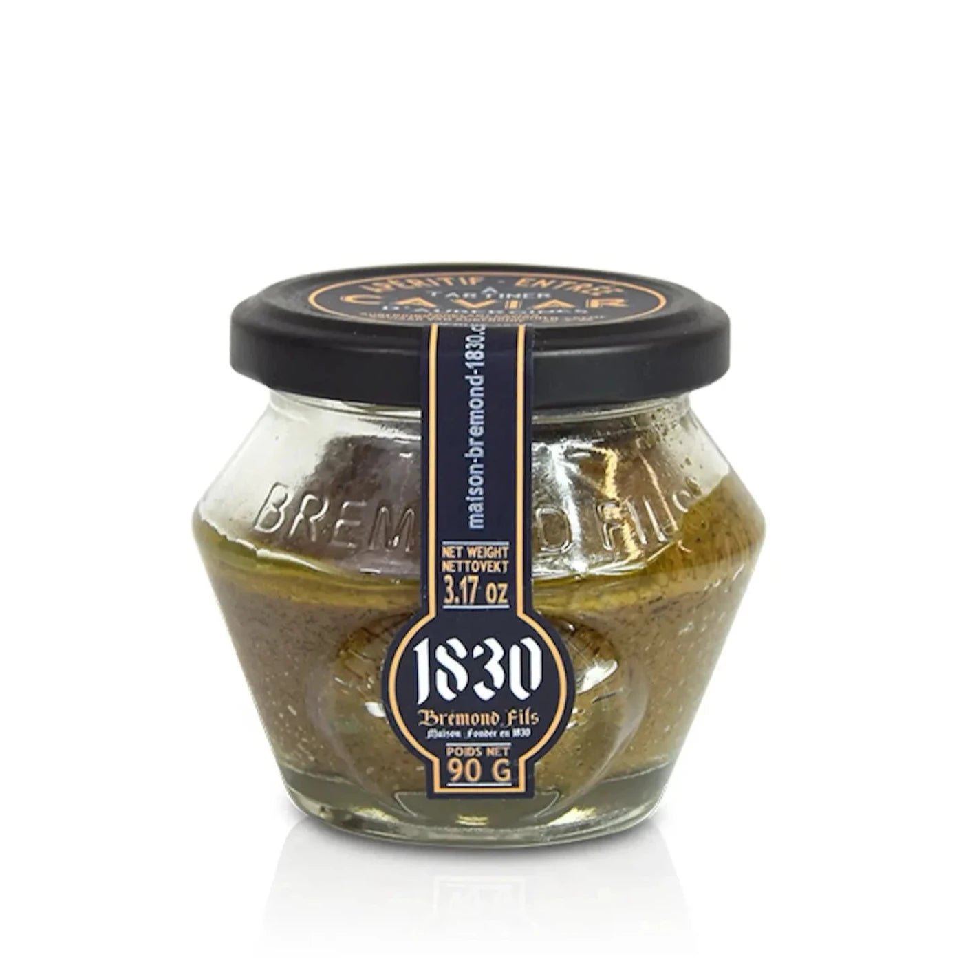 Das Bild zeigt ein Glas mit Auberginen-Creme der Marke "1830 Bremond Fils". Das Glas ist elegant gestaltet, mit einem schwarzen Deckel und einem Etikett, das die Markeninformationen sowie das Nettogewicht von 90 g (3,17 oz) aufführt. Der Inhalt ist sichtbar und besteht aus einer gold-braunen Creme, vermutlich in Olivenöl eingelegt.