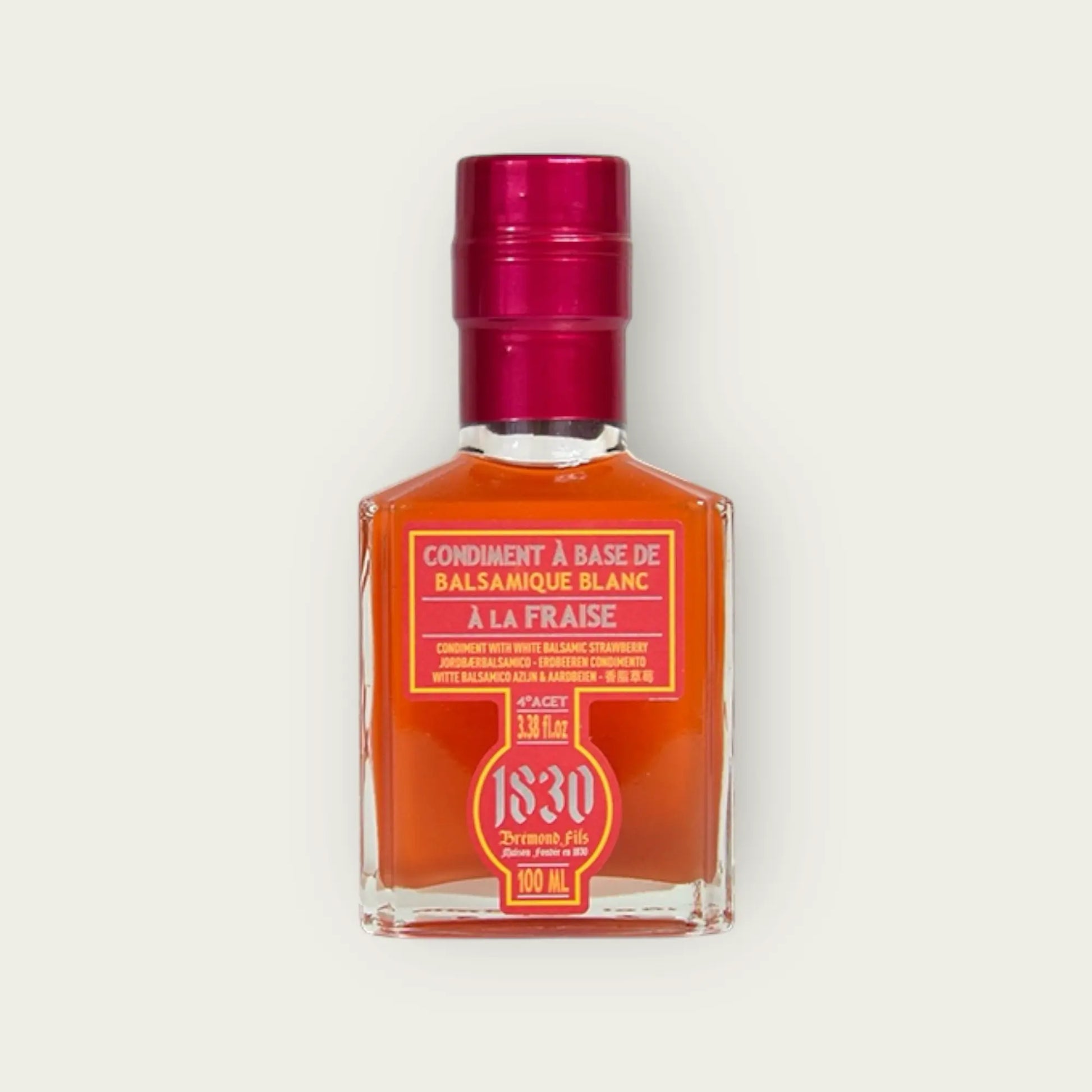 Flasche weißer Balsamico Essig mit Erdbeer-Geschmack, 100 ml, mit glänzend rotem Verschluss und stilvollem Etikett. Perfekt für kreative und fruchtige Rezepte.