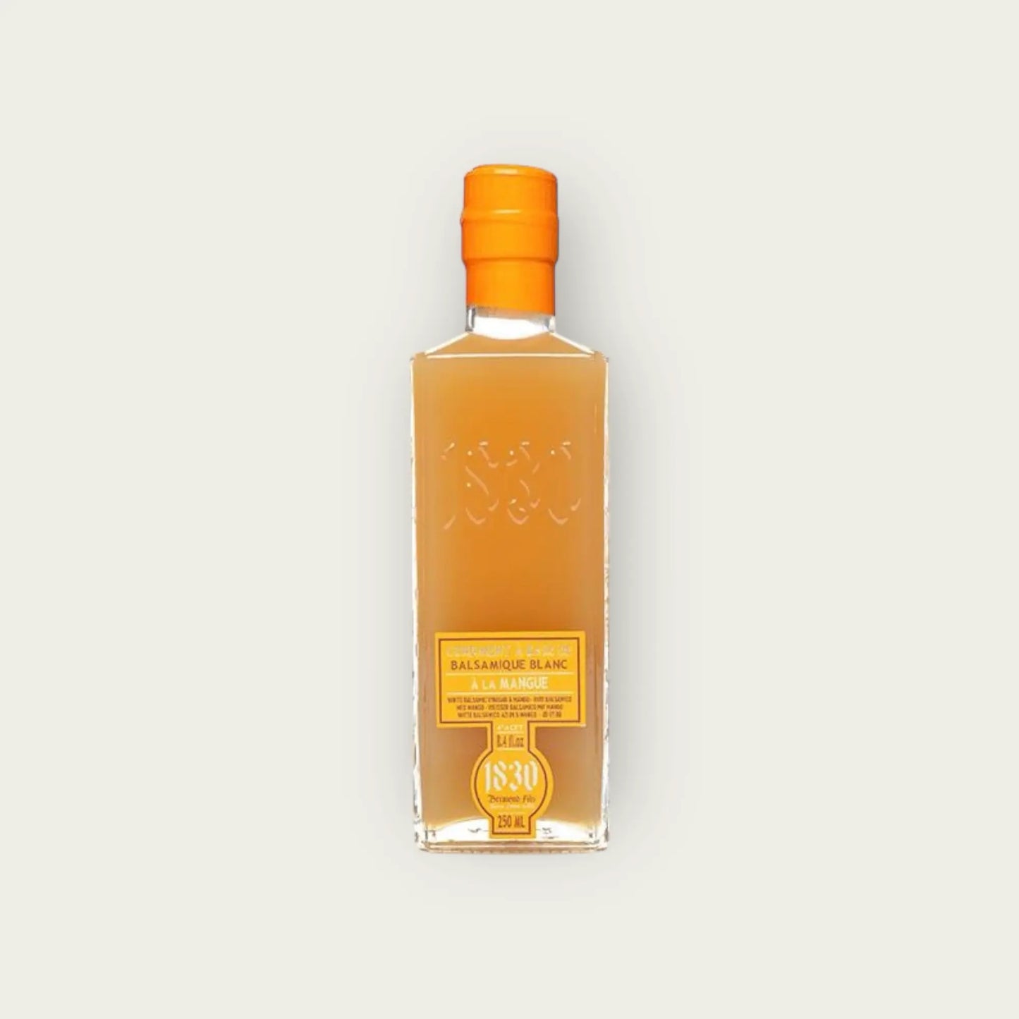 Produktbild einer 250 ml Glasflasche Mango-Balsamico-Essig mit gut lesbarem Etikett auf neutralem Hintergrund.