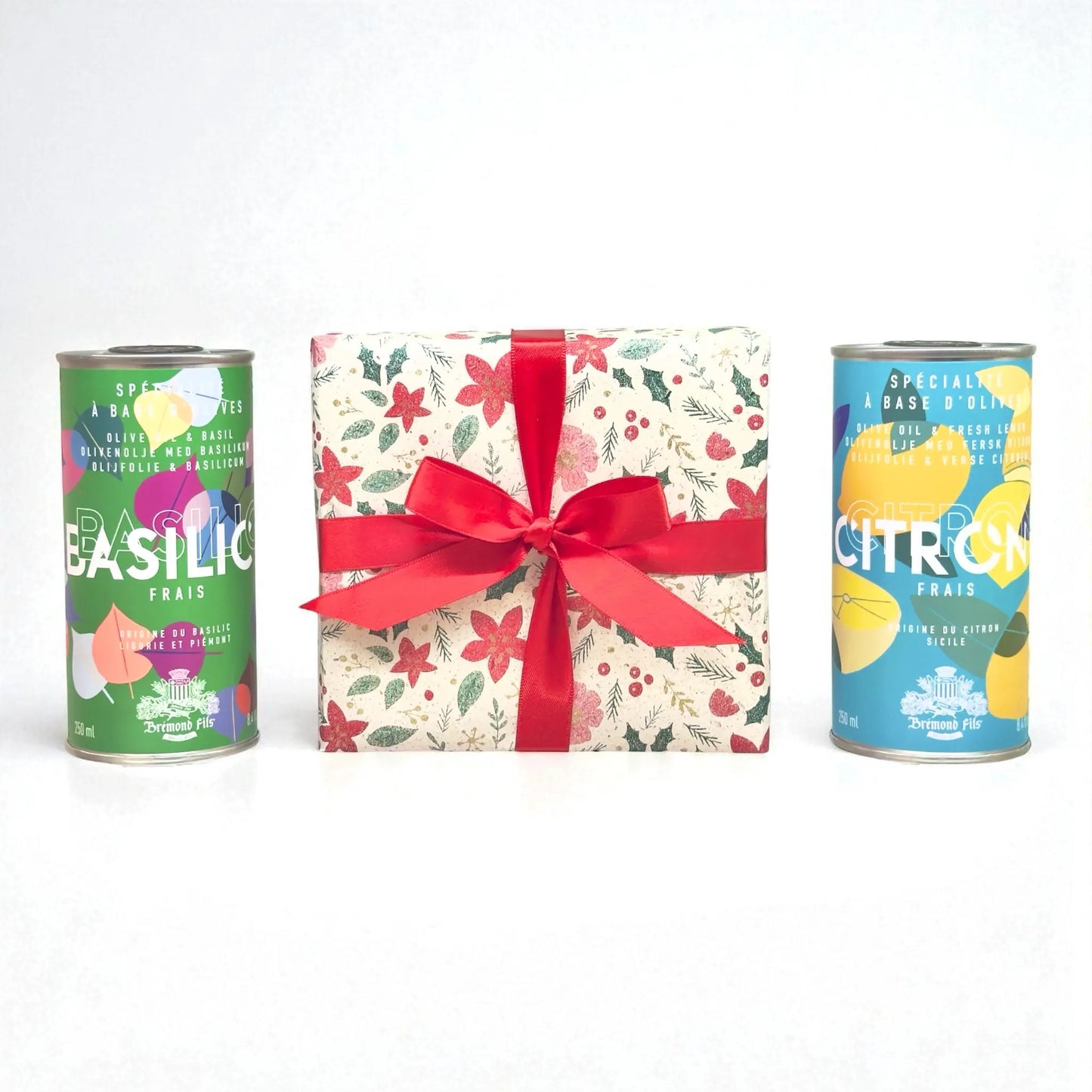 Weihnachts-Geschenkset von Maison Brémond 1830 mit Olivenöl Basilikum und Olivenöl Zitrone in dekorativen Dosen, festlich verpackt mit roter Schleife.
