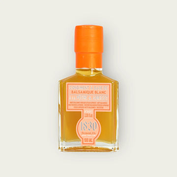 Flasche weißer Balsamico Essig mit Pfirsich und Aprikose, 100 ml, mit leuchtend orangefarbenem Verschluss und stilvollem Etikett. Perfekt für kreative und fruchtige Rezepte.