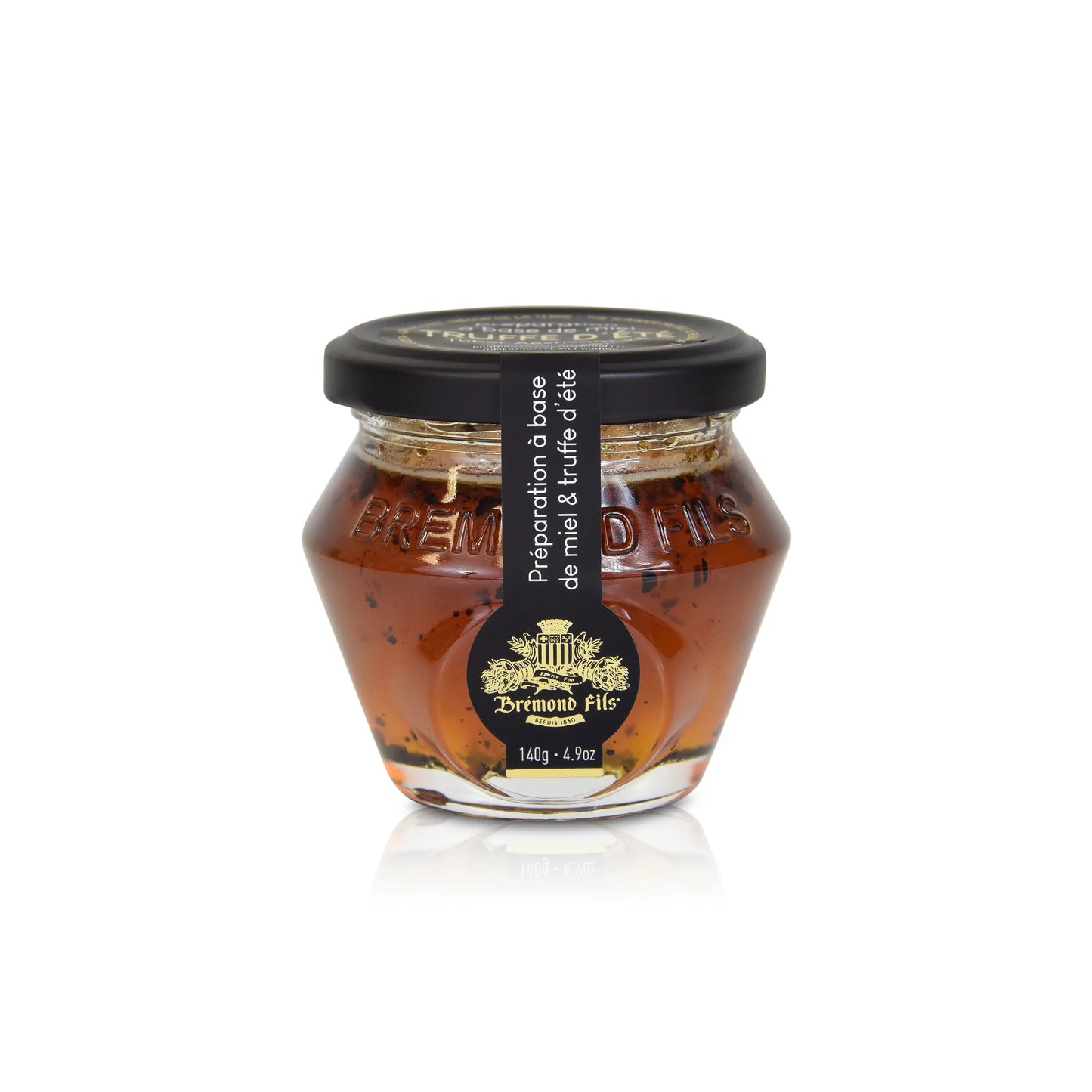 Trueffelhonig.Glas mit Akazienhonig und Sommertrüffelstücken, eleganter schwarzer Deckel mit goldfarbenem Logo "Bremond Fils". Hochwertiges Gourmet-Produkt für Feinschmecker.
