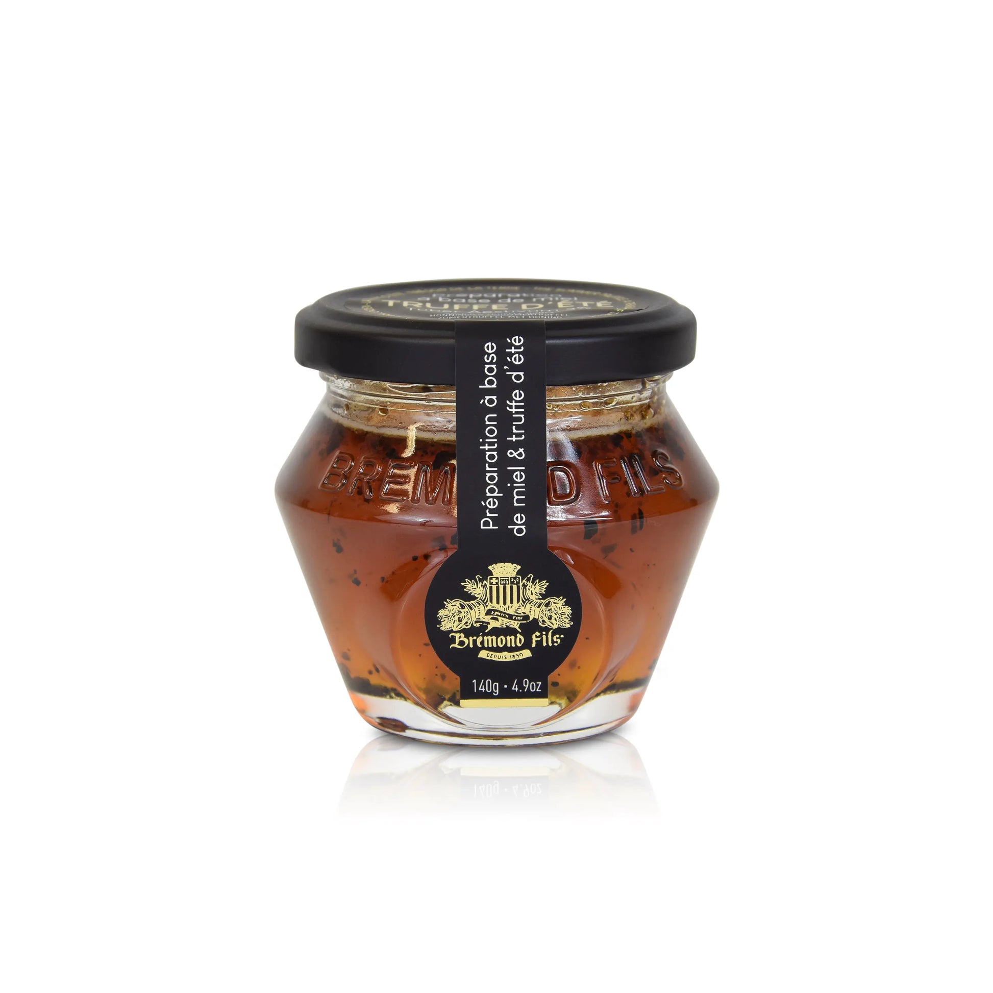 Trueffelhonig.Glas mit Akazienhonig und Sommertrüffelstücken, eleganter schwarzer Deckel mit goldfarbenem Logo "Bremond Fils". Hochwertiges Gourmet-Produkt für Feinschmecker.