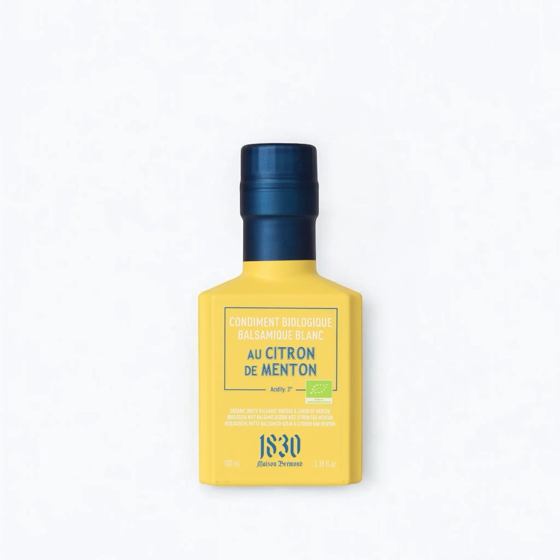 Maison Brémond 1830 Bio Weißer Balsamico Essig mit Zitrone aus Menton in einer eleganten gelben Flasche mit blauem Verschluss.