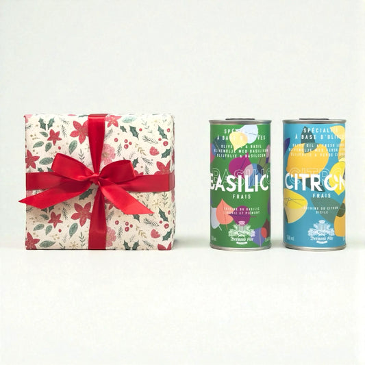 Weihnachts-Geschenkset von Maison Brémond 1830 mit Olivenöl Basilikum und Olivenöl Zitrone in dekorativen Dosen, festlich verpackt mit roter Schleife.